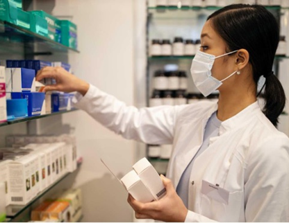 Pharmacist choosing medications from a shelf