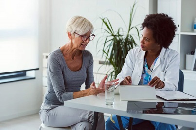 Doctor speaking with a concerned and animated older female patient