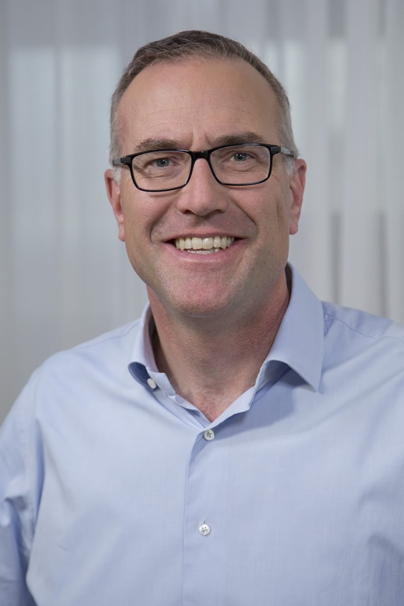 A photograph of Alexander Hardy, Chief Executive Officer of Genentech