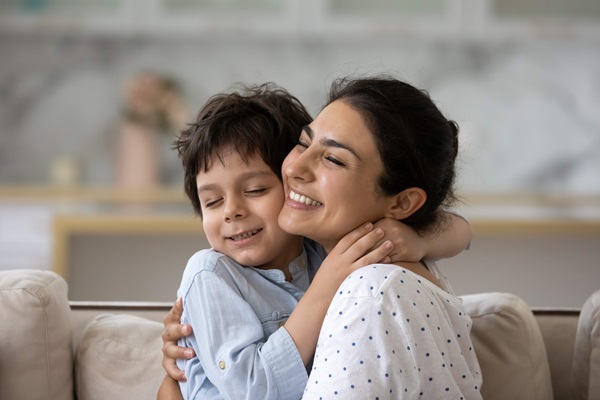 Mother and son happily hugging