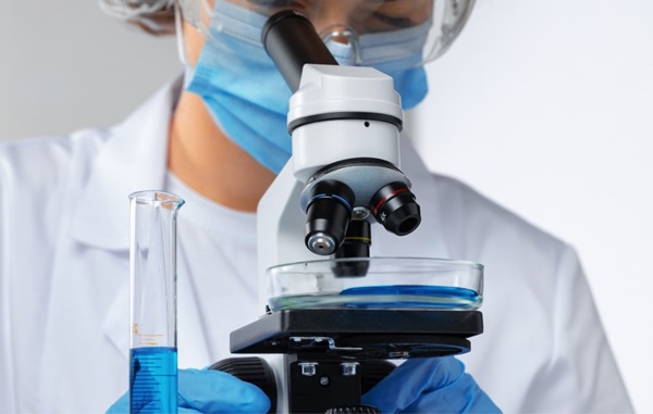 Woman scientist looking at microscope