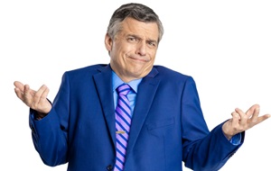 Man in a blue suit throwing his hands upward in a dismissive shrug