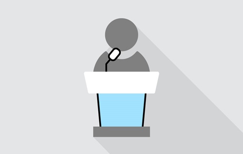 Illustrated depiction of a person at a lectern with microphone